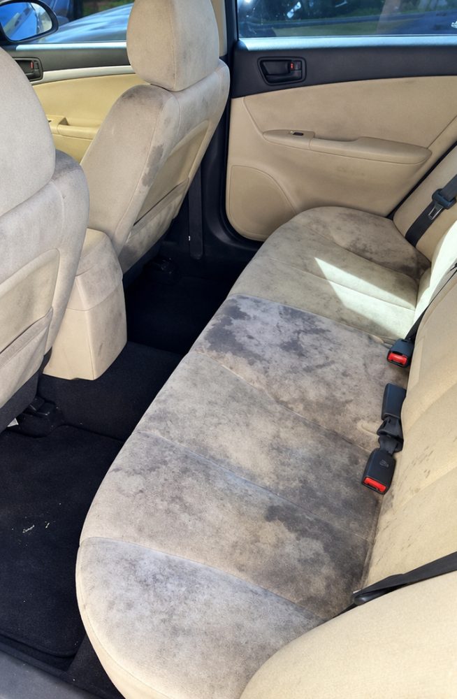 Before: stained grey fabric rear seat