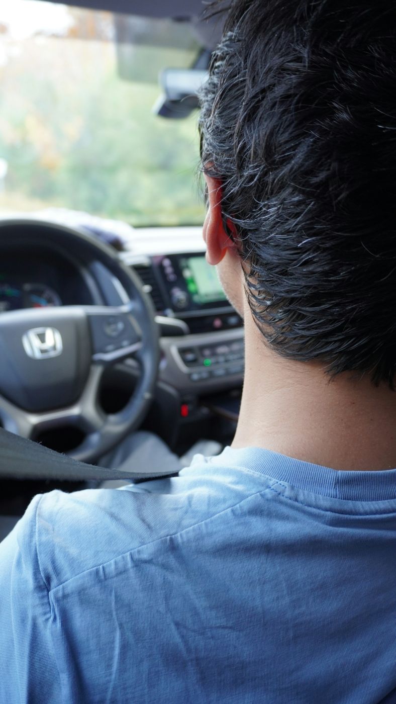 Driver on a daily commute in a clean car interior