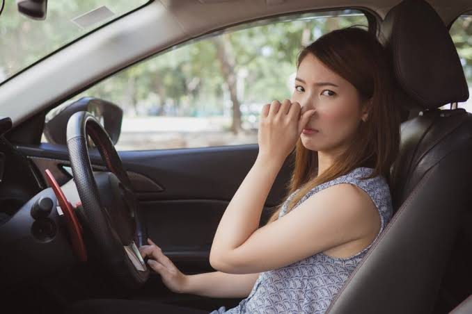 Driver noticing an unpleasant odor inside her car