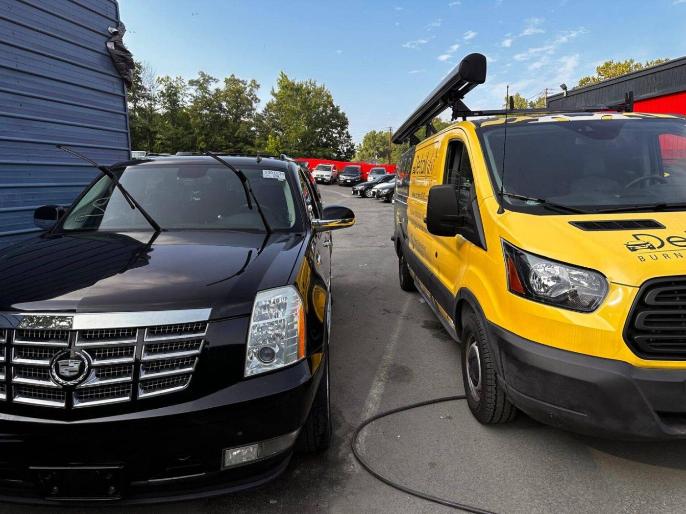 Car Detail 360 van next to a black Cadillac Escalade at a dealership