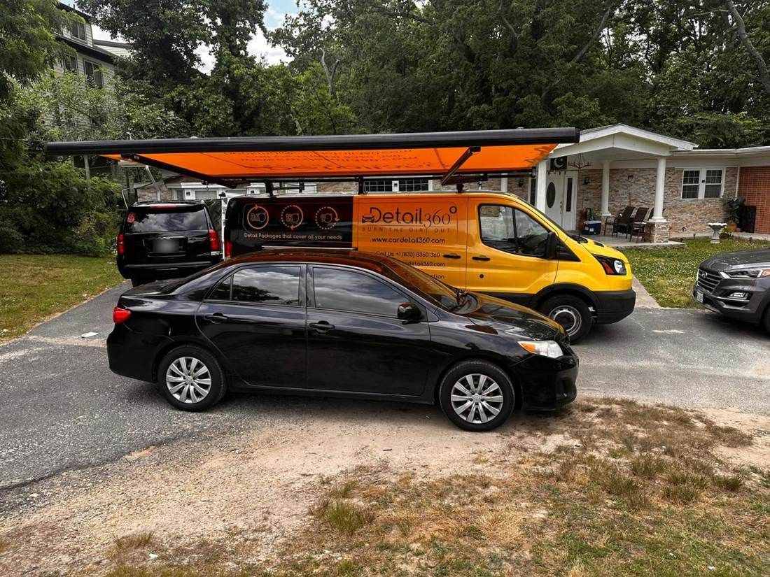 Car Detail 360 mobile unit working on a black Toyota Corolla at a customer's home
